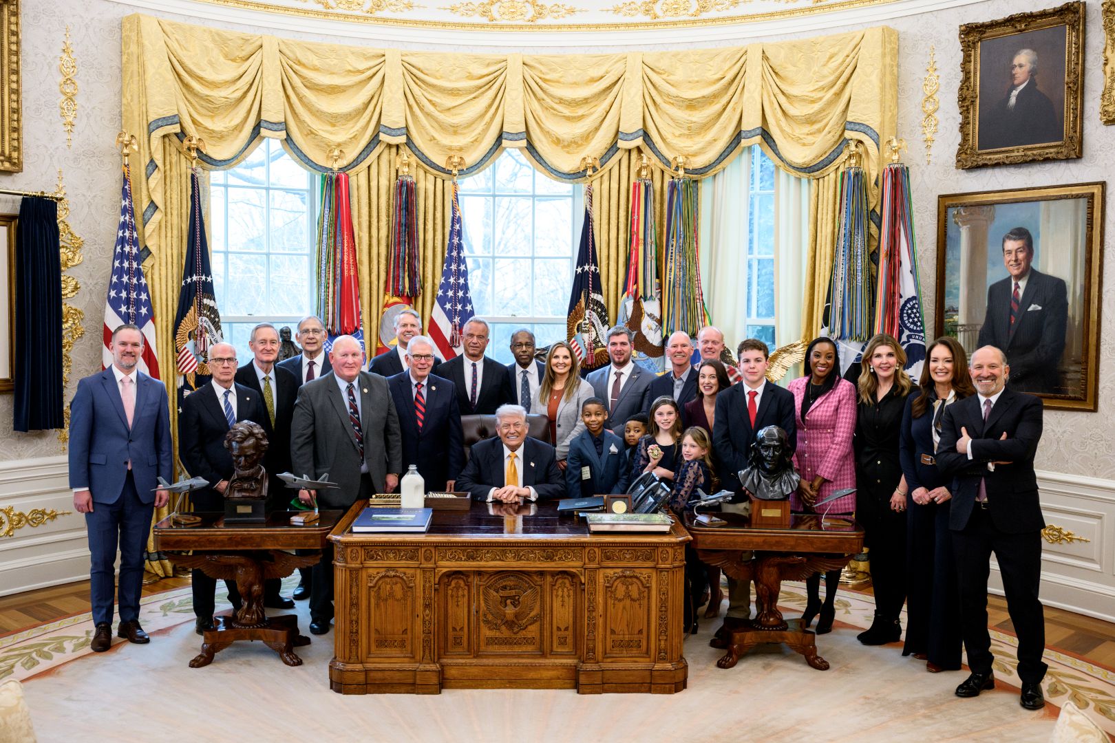 Members of Congress gather with the President before the bill is signed into law 