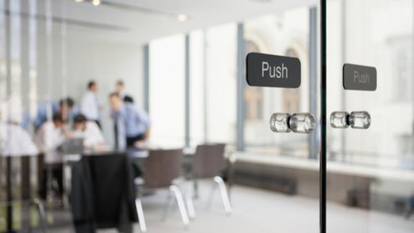 Office meeting behind glass doors
